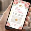 Convite de casamento rosa interativo com envelope digital, flores rosas, alianças douradas e lacre elegante.